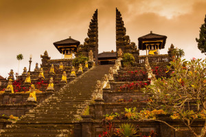 BESAKIH TEMPLE. The holiest of all temples in Bali, the "Mother Temple" of Pura Besakih is located some 3,000 feet up Gunung Agung in East Bali. This sprawling complex consolidates 23 separate temples, some dating back to the 10th century. The temple's main axis aligns with the peak of Gunung Agung, the tallest mountain and holiest site in all of Bali. Pura Besakih narrowly escaped destruction in 1963, as lava flow from Gunung Agung's killer eruption missed the temple by mere yards. Today, Pura Besakih is a major draw for tourists and for devout Balinese. (For other tourist attractions in this part of the island, read: Places to See in East Bali.